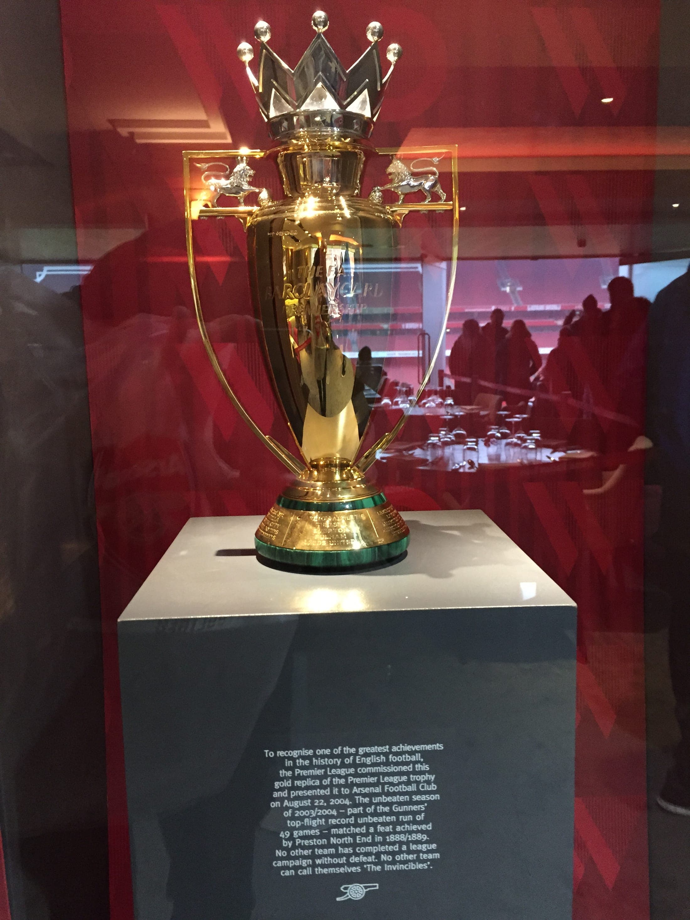 The gold replica Premier League trophy presented to Arsenal for the unbeaten 2003/04 season, on display at the Emirates Stadium