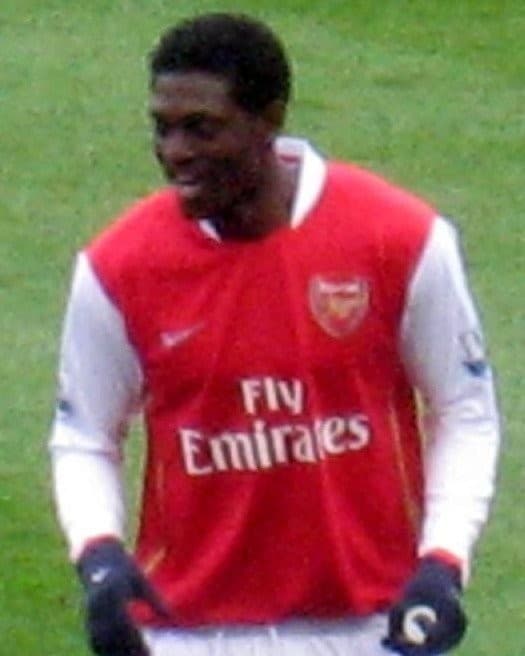 Emmanuel Adebayor in Arsenal kit, number 25, on the pitch in winter gloves
