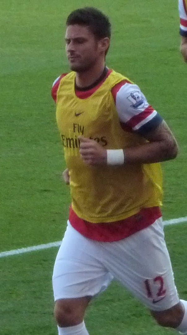 Olivier Giroud in Arsenal kit, number 12, warming up before a match